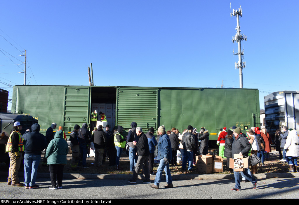 Boxes of gifts being loaded onto the Reading Boxcar # 19028